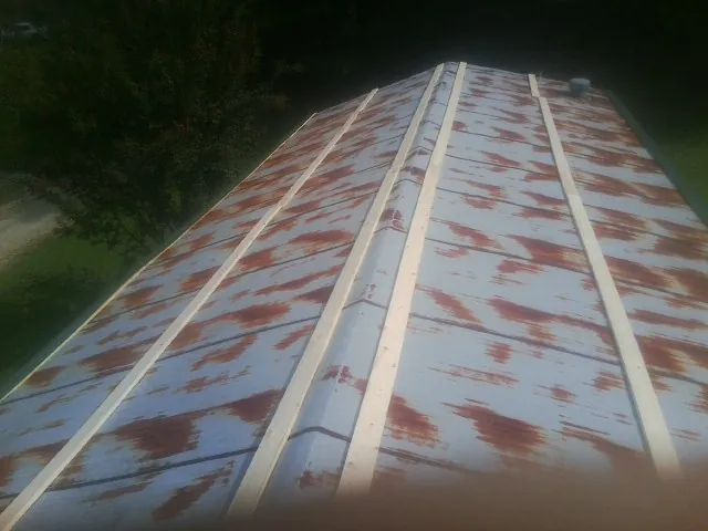 Rusted metal roof panels with new wood purlins before replacement — Storm Damage Roof Repair in Campbell by Roofing Brothers